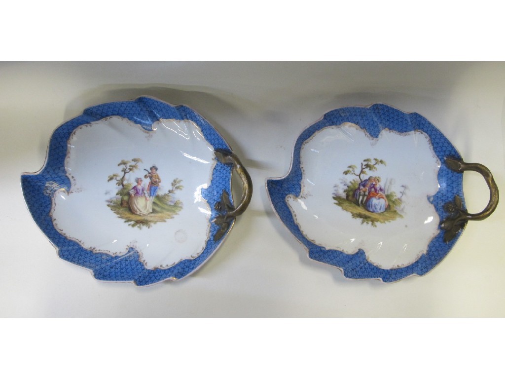 Appraisal: Pair of continental porcelain leaf shape dishes decorated with scenes