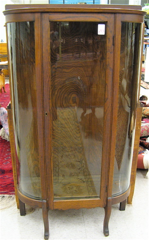 Appraisal: AN OAK AND CURVED GLASS CHINA DISPLAY CABINET American early