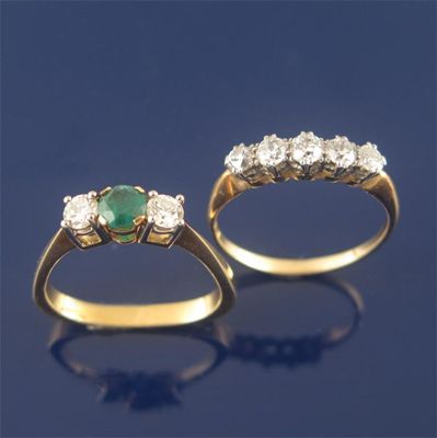 Appraisal: An emerald and diamond three stone ring and a diamond