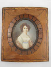 Appraisal: An oval miniature on card of a young girl in