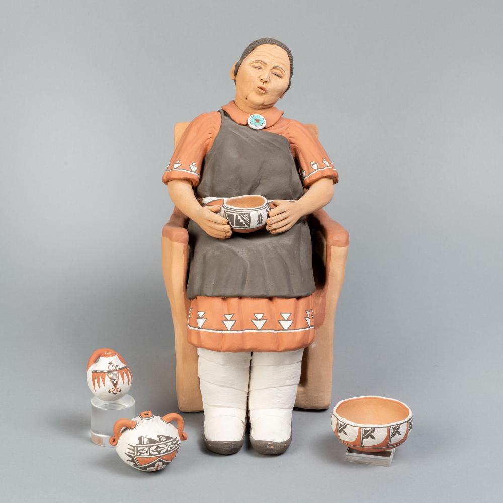 Appraisal: POTTERY WOMAN FIGURINE WITH POTTERY CA Pottery Woman Figurine with