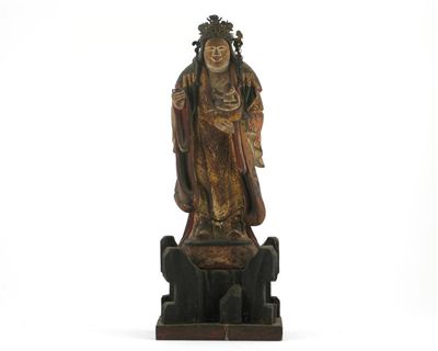 Appraisal: A carved wood standing figure of Kishimojin holding a small