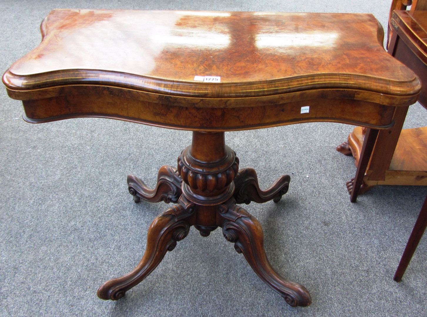 Appraisal: A Victorian figured walnut card table the serpentine top on