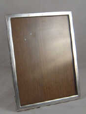 Appraisal: A silver photo frame with oak back and strut marked