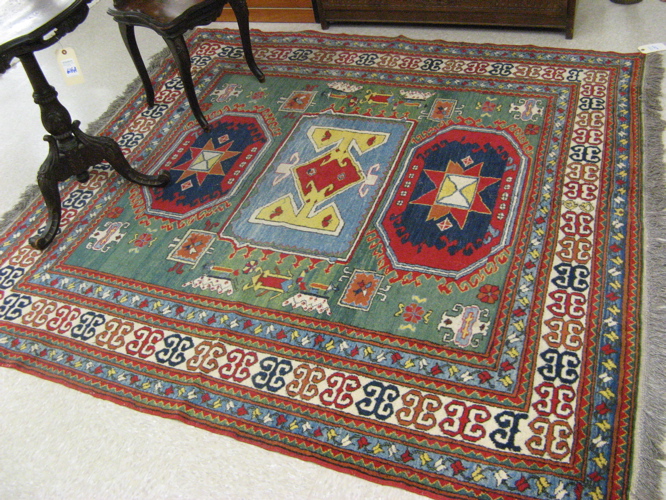 Appraisal: PAKISTANI KAZAK AREA RUG centering a column of three geometric