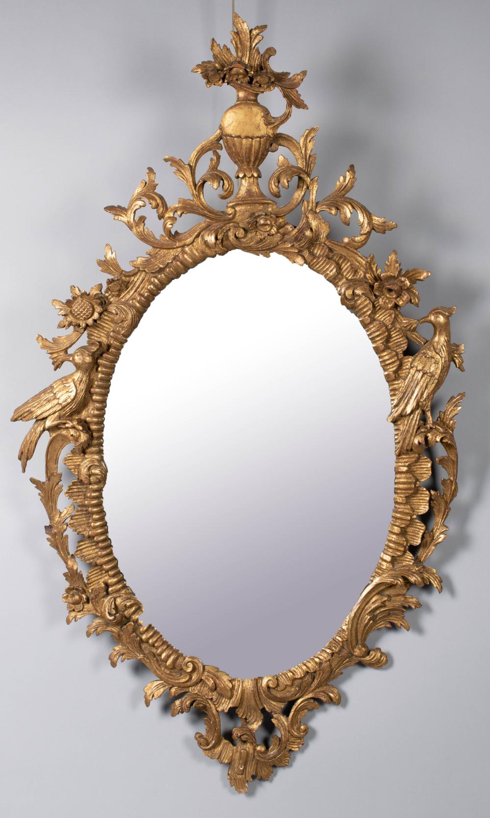 Appraisal: GEORGE III STYLE GILTWOOD MIRROR the oval plate in a