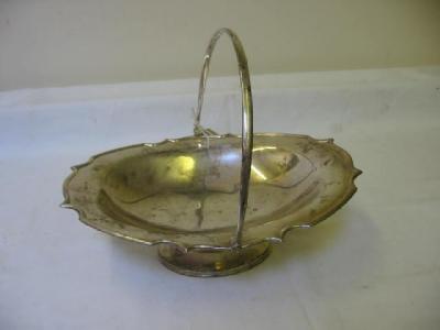 Appraisal: AN EDWARDIAN FRUIT BASKET of oval pedestal form with swing