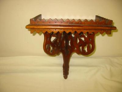 Appraisal: A VICTORIAN GOTHIC WALNUT BRACKET SHELF the oblong top with