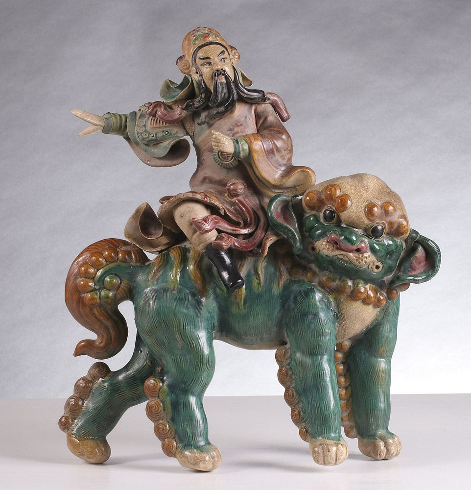 Appraisal: AN ANTIQUE CHINESE GLAZED FIGURAL ROOF TILE The figure astride