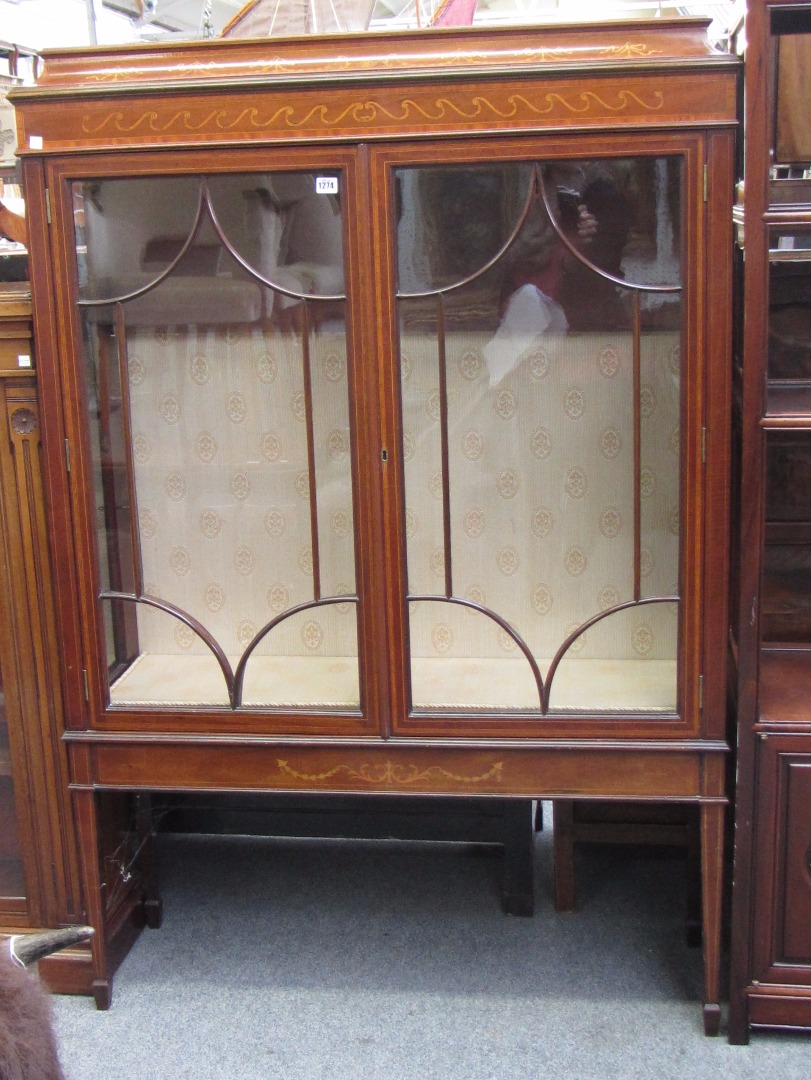 Appraisal: An Edwardian marquetry inlaid display cabinet the caddy top over