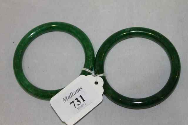 Appraisal: A PAIR OF SPINACH JADE BANGLES