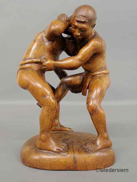 Appraisal: Carved wood figural group of two men wrestling probably Malaysian