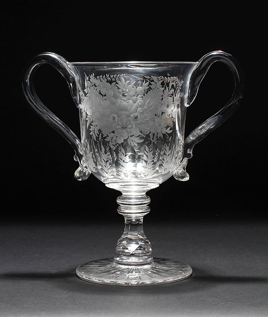 Appraisal: A VICTORIAN TWO HANDLED GLASS LOVING CUP with flower engraving