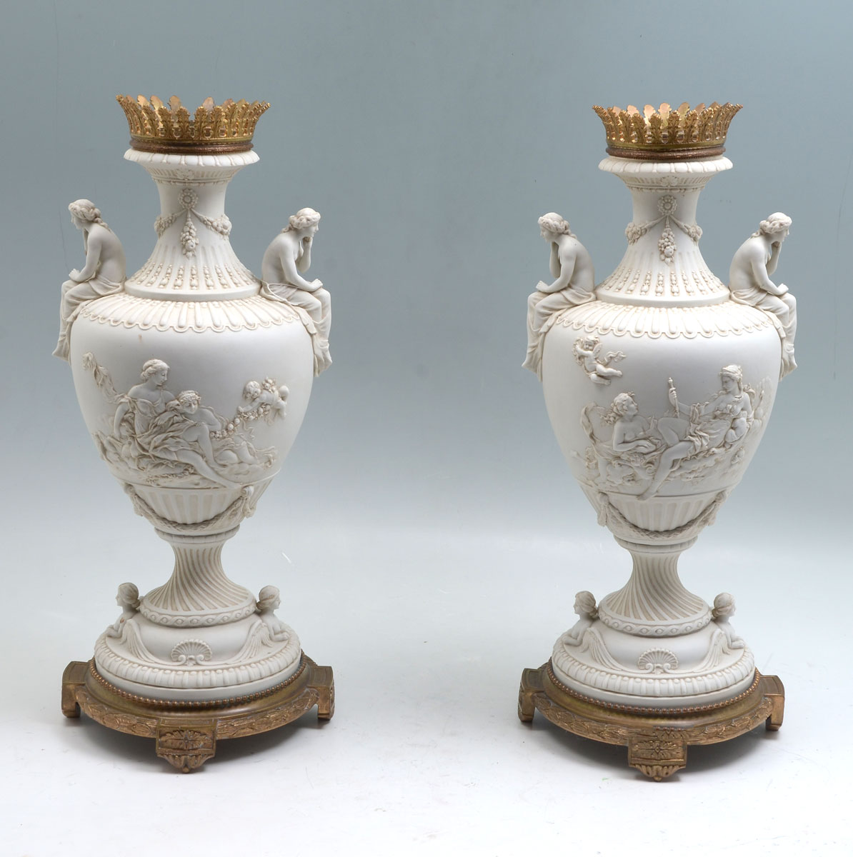 Appraisal: PAIR OF PARIAN URNS Having semi-nude females angels with playful