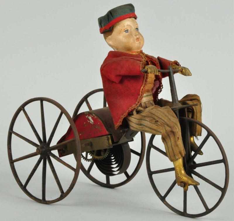 Appraisal: Early Tin George Brown Boy on Velocipede Toy Description American