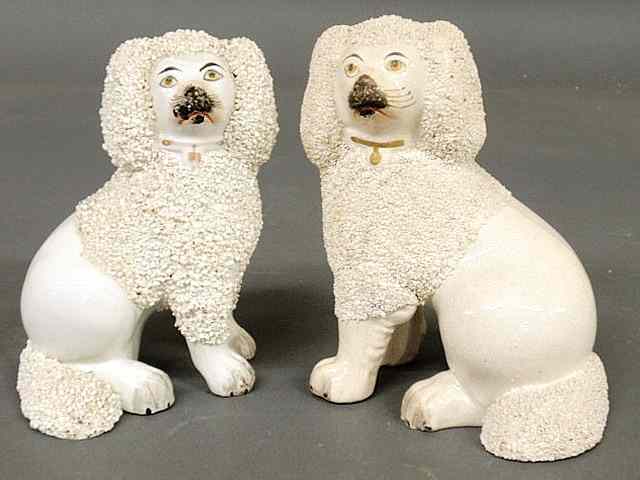 Appraisal: Two th c Staffordshire seated white poodles tallest h