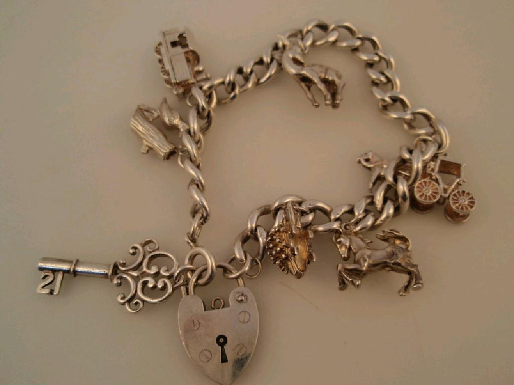 Appraisal: A silver charm bracelet with eight silver charms weight gms