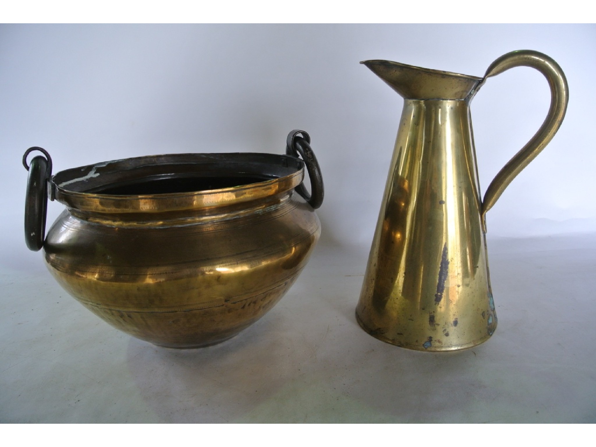 Appraisal: A brass ewer and a th century Eastern brass bowl