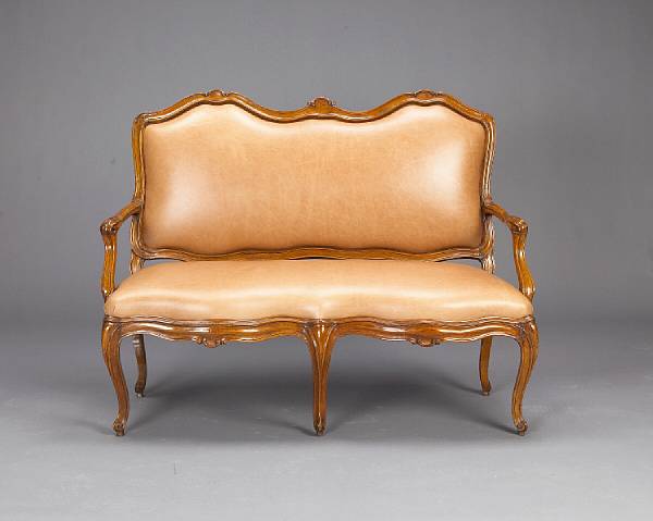 Appraisal: A Louis XV style walnut and leather upholstered canape th