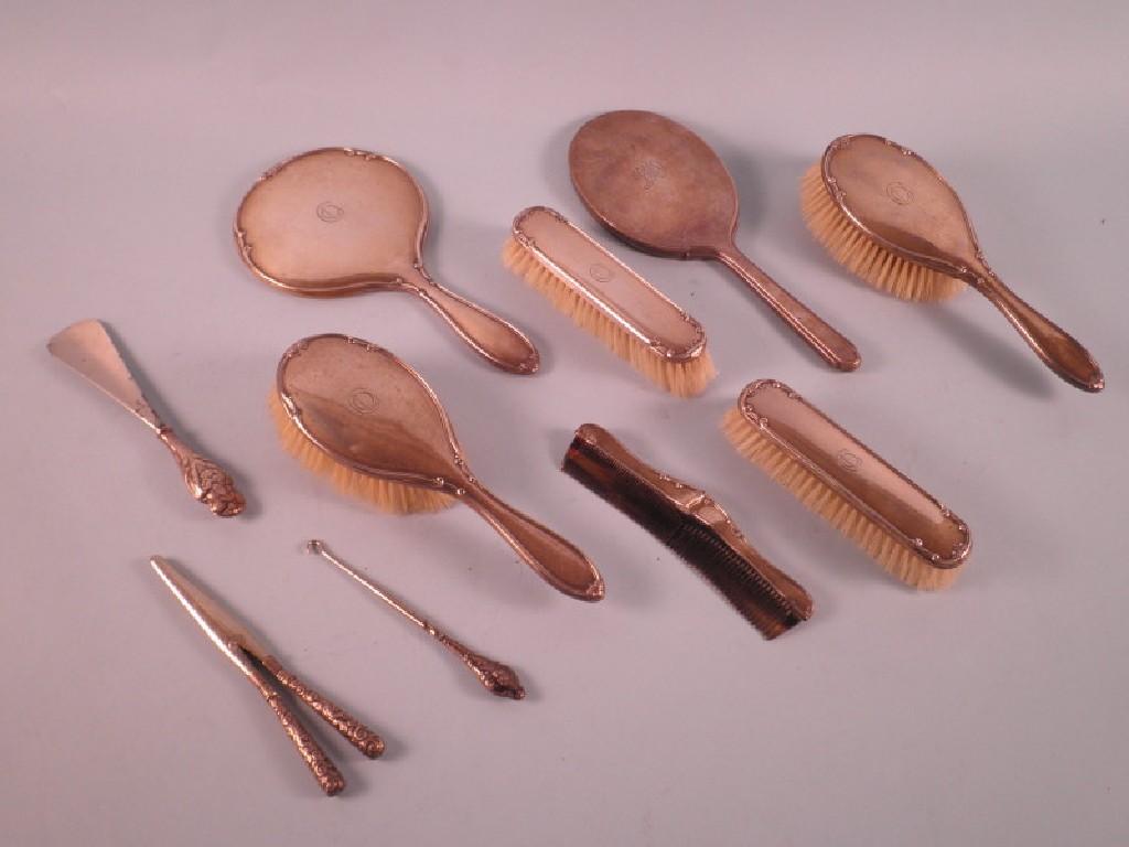 Appraisal: A silver piece dressing table set comprising four brushes and