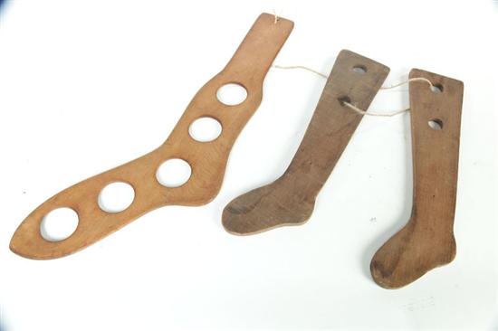 Appraisal: THREE STOCKING STRETCHERS American th century Large footed stretcher in