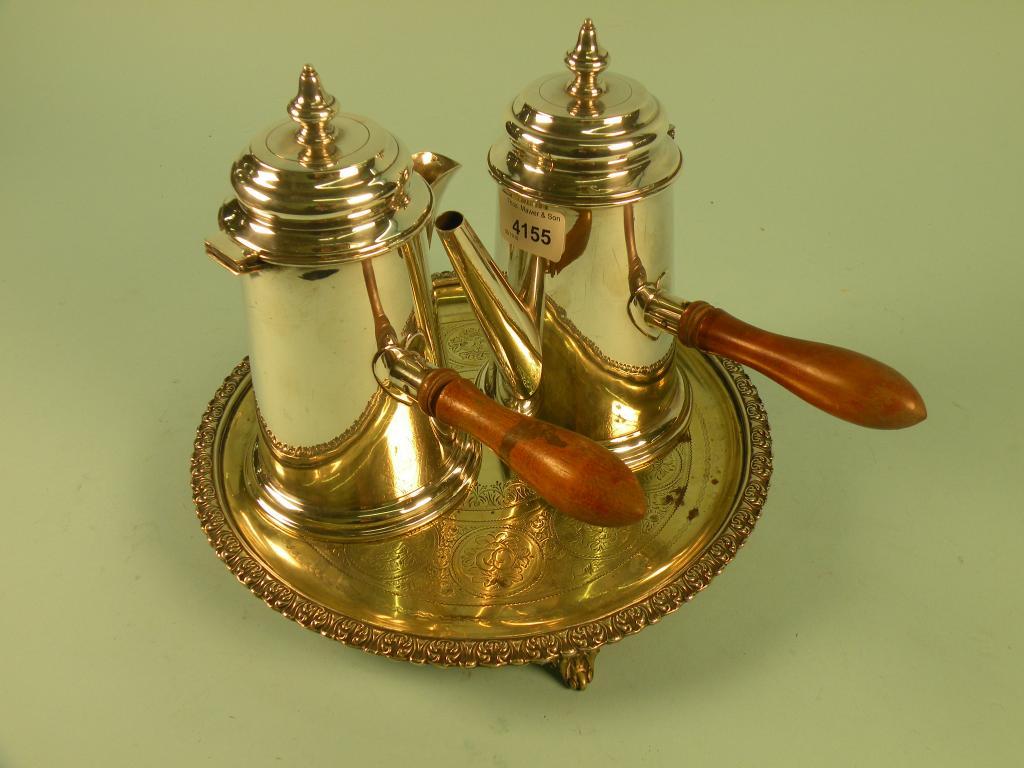 Appraisal: A pair of silver plated argyles each with a turned