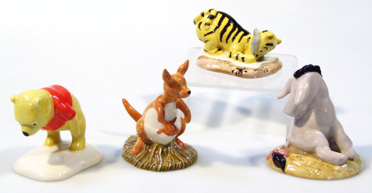 Appraisal: Four Royal Doulton Winnie The Pooh porcelain figures Eeyore's Tail