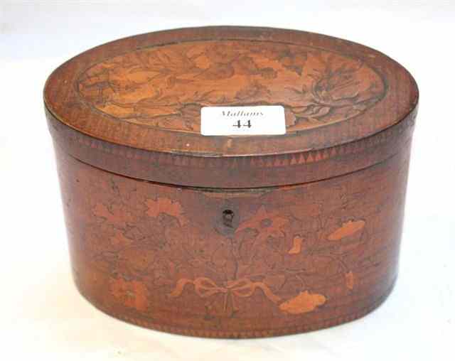 Appraisal: A GEORGE III MAHOGANY OVAL TEA CADDY with twin divisional