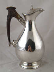 Appraisal: A silver plated hot water jug with antler handle ht