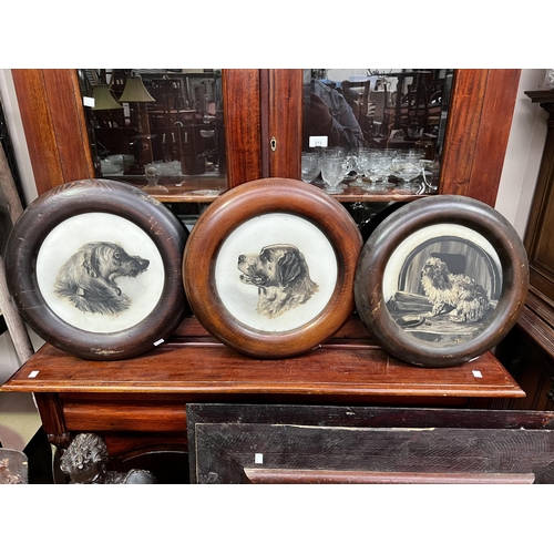 Appraisal: Three antique milk glass painted dogs in circular frames frame