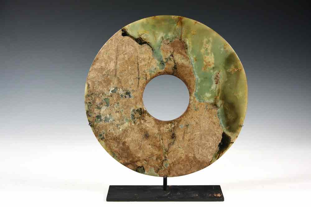 Appraisal: CHINESE DISC - Ancient Chinese jade Bi disc in green