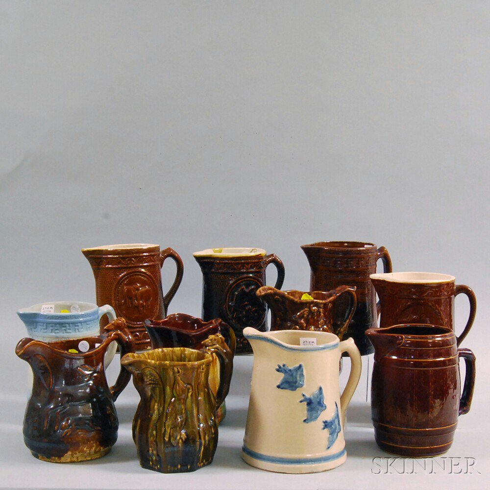 Appraisal: Eleven Mostly Rockingham-glazed Pitchers including a cask-form pitcher a flying