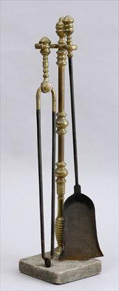 Appraisal: TWO BRASS-HANDLED FIRE TOOLS AND ASSOCIATED STAND Comprising a shovel