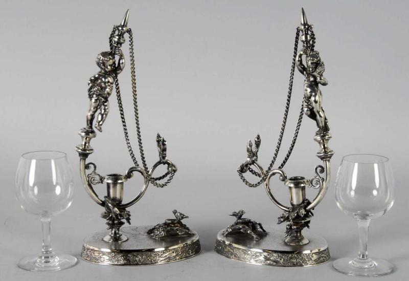 Appraisal: Pair of Silver Plated Figural Wine Glass Holders Description Wilcox