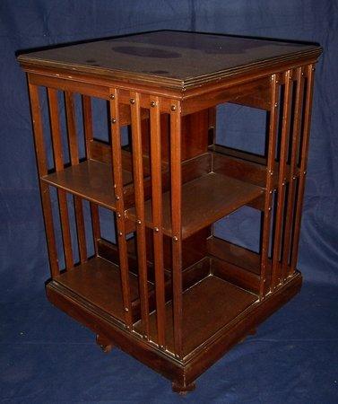 Appraisal: An Edwardian square mahogany revolving bookcase with slatted sides cm