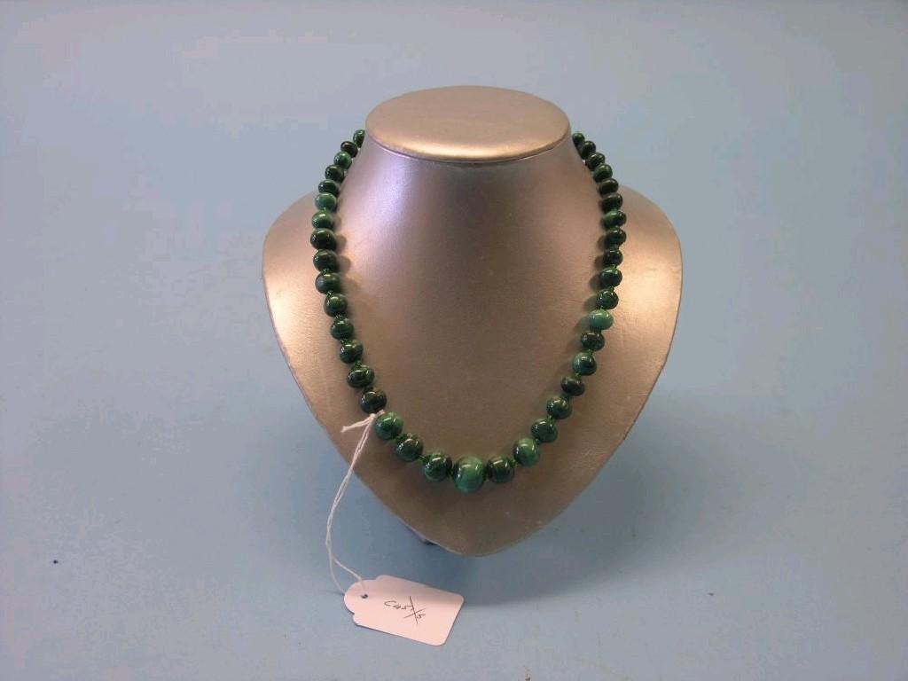 Appraisal: A malacite bead necklace on stand