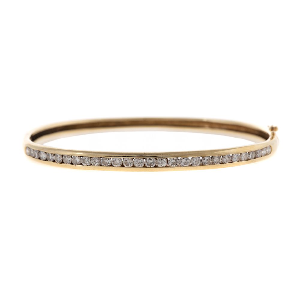 Appraisal: A Channel Set Diamond Bangle Bracelet in K K yellow