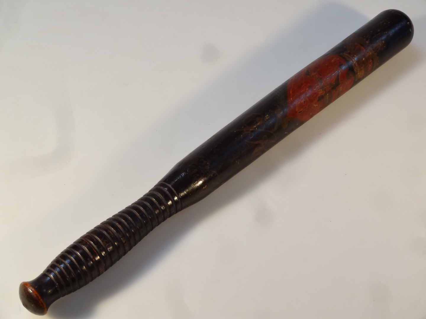 Appraisal: A Victorian ebonised oak truncheon the moulded handle painted with