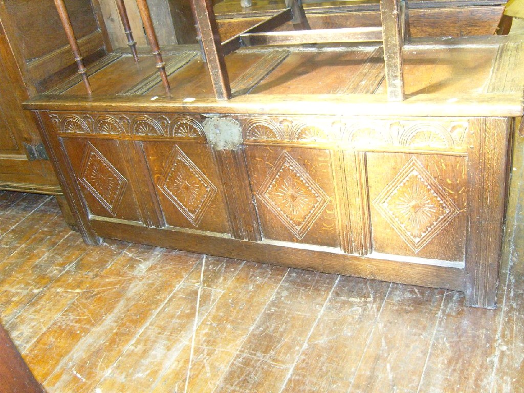 Appraisal: A Georgian oak coffer with carved and panelled front elevation