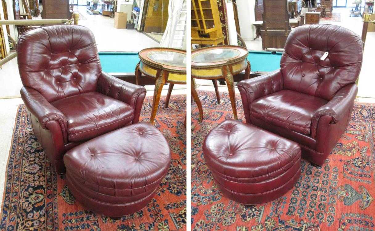 Appraisal: A PAIR OF BURGUNDY LEATHER RECLINERS WITH MATCHING OTTOMANS Hancock