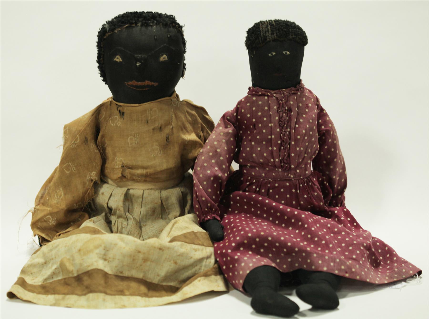 Appraisal: TWO EARLY BLACK CLOTH DOLLS WITH STITCHED AND PAINTED FEATURES