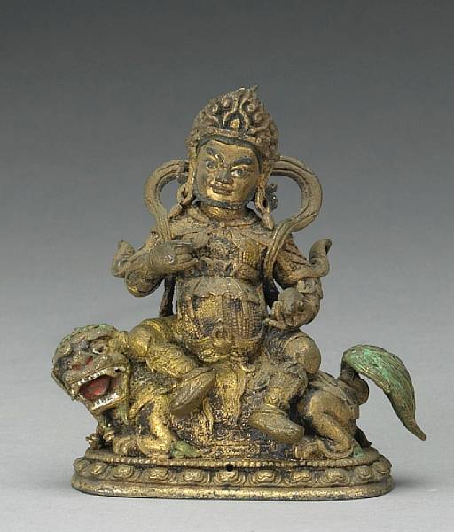 Appraisal: A small Tibetan gilt bronze figure of Jambhala seated on