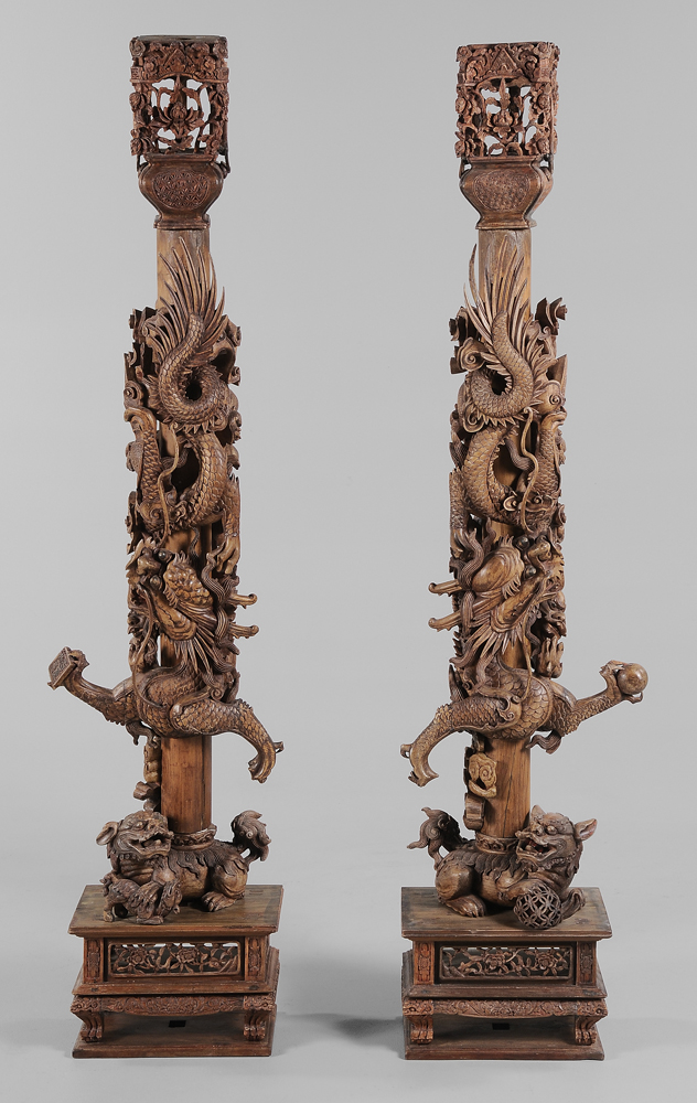 Appraisal: Pair Carved Hardwood Dragon Columns Chinese each elaborately carved with