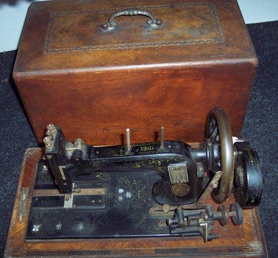 Appraisal: A Victorian sewing machine with mother-of-pearl inlay in a mahogany