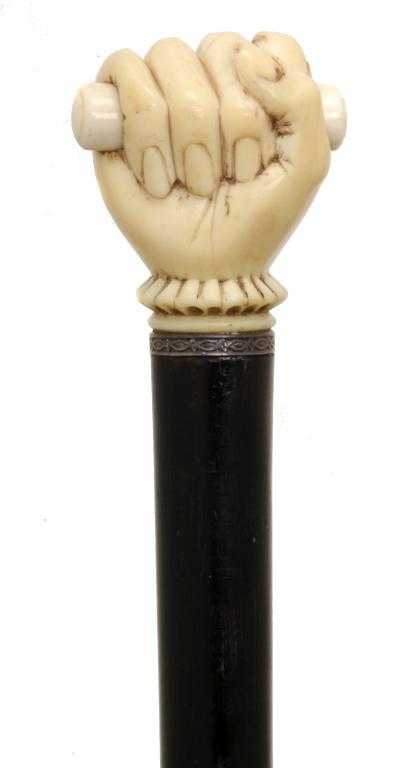 Appraisal: AN IVORY-HANDLED WALKING CANE of probably ebony the handle carved