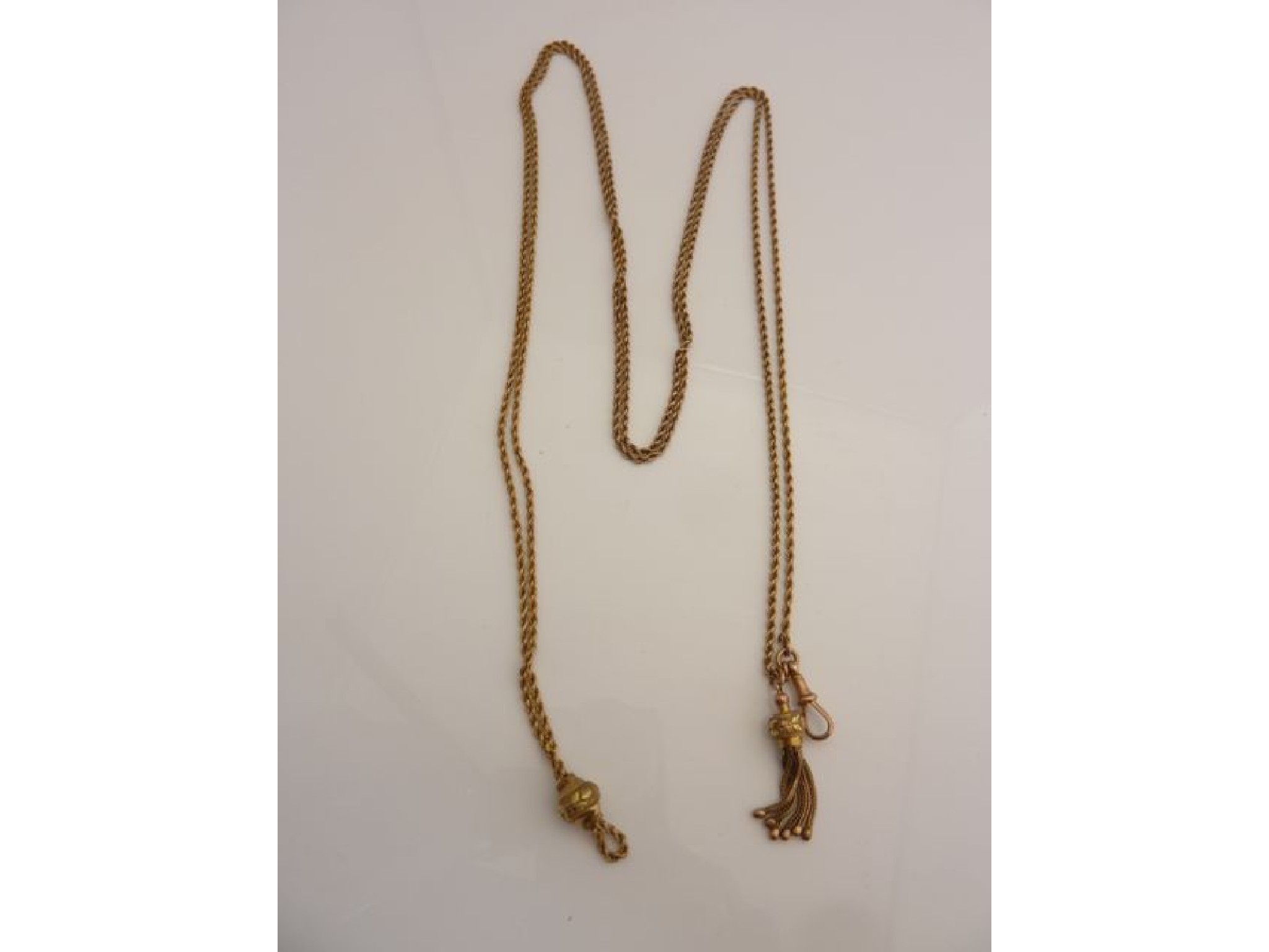 Appraisal: A ct gold rope-twist watch chain with multi-coloured gold floral