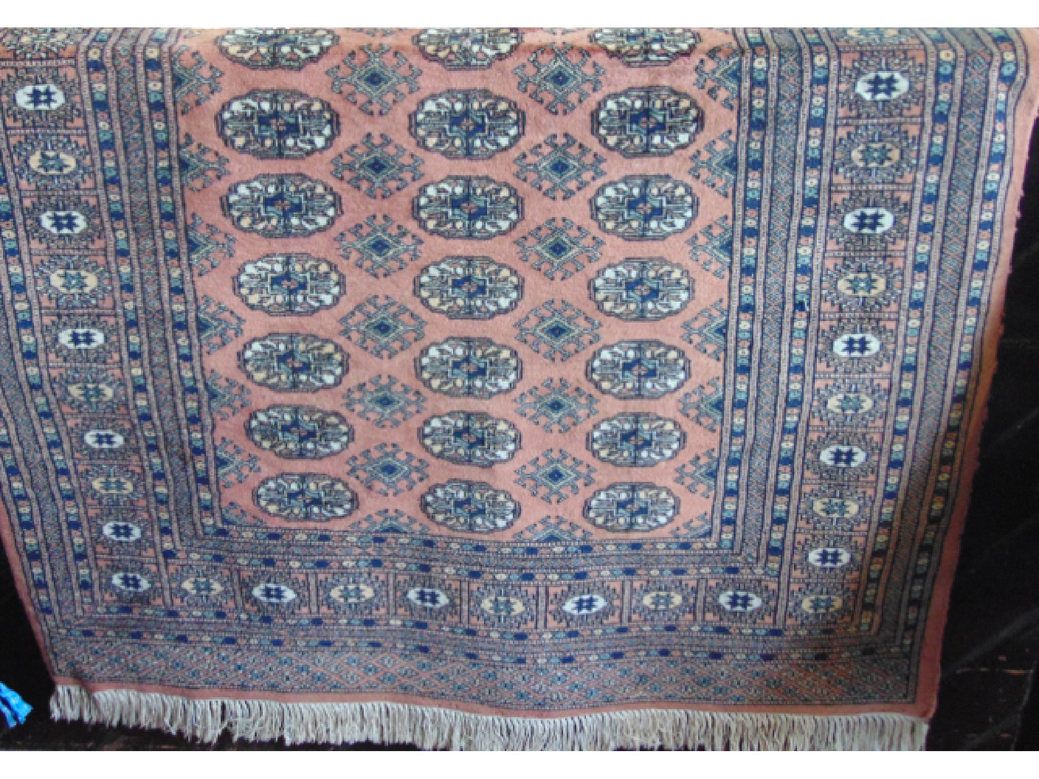 Appraisal: An Afghan style wool work rug with pale pink field