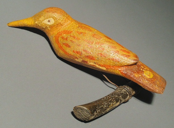 Appraisal: German folk art carved bird on a branch with yellow