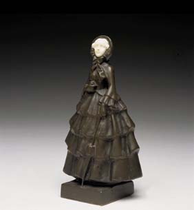 Appraisal: BRONZE AND IVORY FIGURE Continental bronze figure of a woman