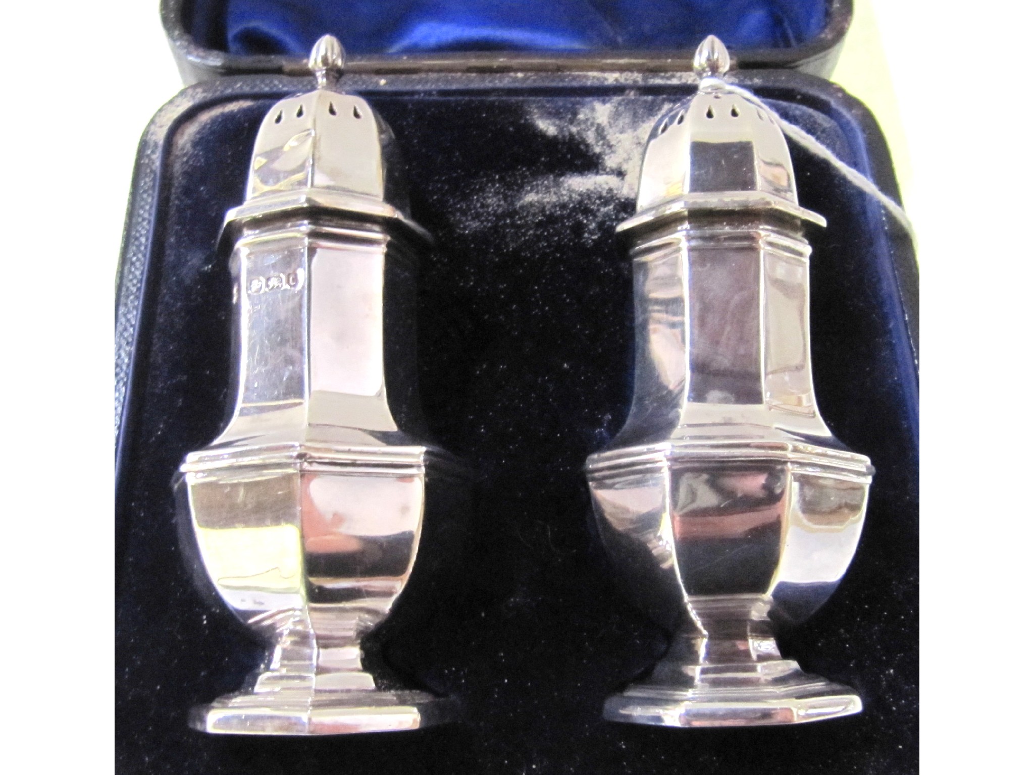 Appraisal: A cased pair of silver pepper pots Sheffield